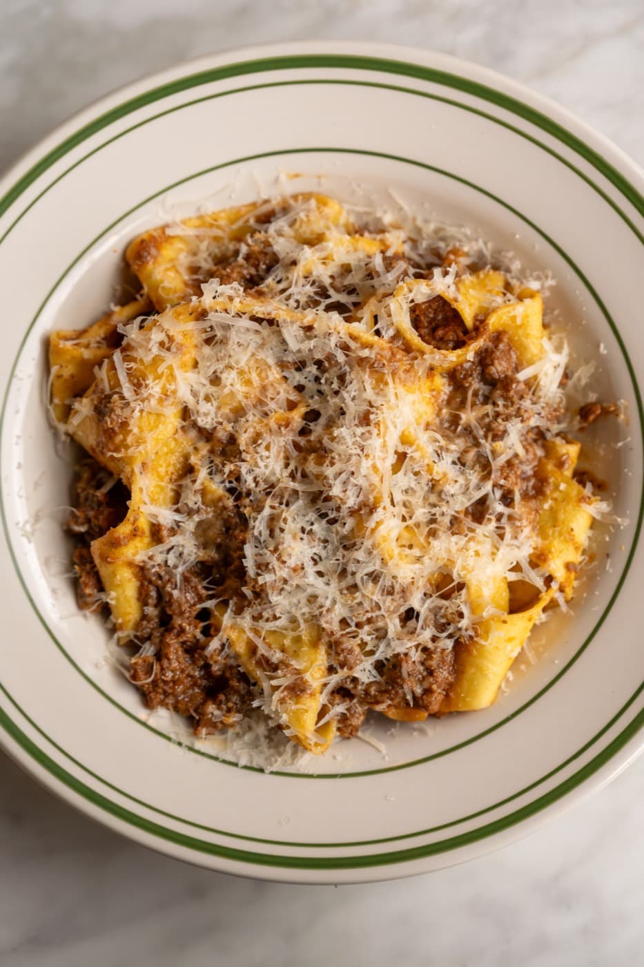 Pappardelle with a long-cooked ragù, under grated cheese