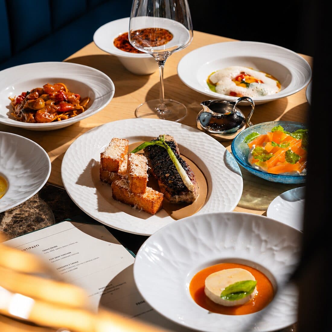 Plates from the menu, set out across a table in the dining room